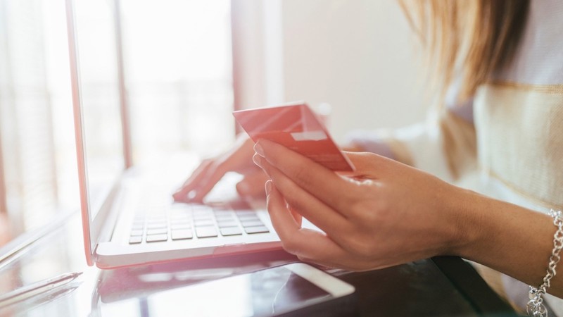 Woman, laptop and card